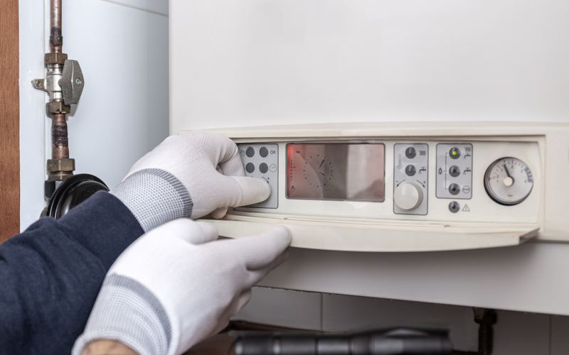 Engineer checking boiler controls